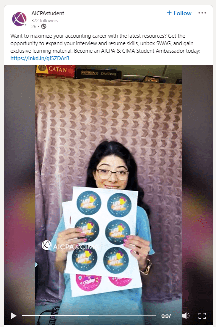 Snippet of accounting student holding stickers from AICPA & CIMA.